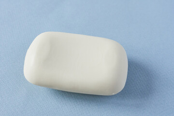 White soap on a blue background. Shallow depth of field.