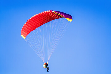 Paraglider on a clear blue summer sky