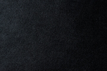 Black textured background with a smooth gradient from light to shadow. Seamless textured effect....
