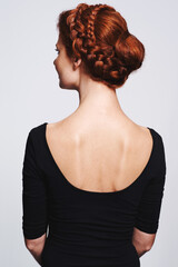 Back view of woman, hair and braid hairstyle for beauty, elegant redhead with glamour and cosmetology on white background. Haircare, luxury or regal, Irish model with plait or twist for cosmetic care - obrazy, fototapety, plakaty