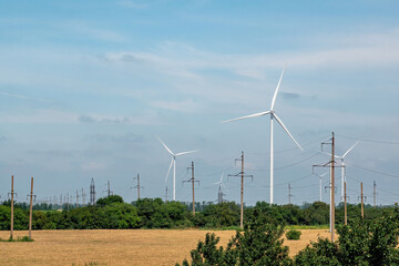 Windmills produce alternative energy transferred by high voltage lines. Production of clean form of...