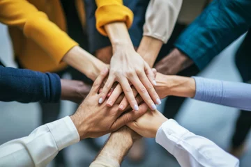 Foto op Plexiglas Diverse group of businesspeople stacking hands together in unity © Robert Kneschke