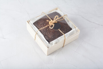 premium freshly baked dark cocoa chocolate brownie square birthday cake with walnut peanut almond in wood bento box on white marble halal food gluten free sweet dessert menu for pastry cafe shop