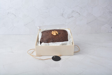 premium freshly baked dark cocoa chocolate brownie square birthday cake with walnut peanut almond in wood bento box on white marble halal food gluten free sweet dessert menu for pastry cafe shop