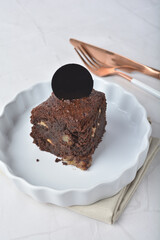 premium freshly baked dark cocoa chocolate brownie square birthday cake with walnut peanut almond in wood bento box on white marble halal food gluten free sweet dessert menu for pastry cafe shop