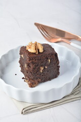 premium freshly baked dark cocoa chocolate brownie square birthday cake with walnut peanut almond in wood bento box on white marble halal food gluten free sweet dessert menu for pastry cafe shop