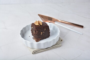 premium freshly baked dark cocoa chocolate brownie square birthday cake with walnut peanut almond in wood bento box on white marble halal food gluten free sweet dessert menu for pastry cafe shop