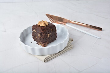 premium freshly baked dark cocoa chocolate brownie square birthday cake with walnut peanut almond in wood bento box on white marble halal food gluten free sweet dessert menu for pastry cafe shop