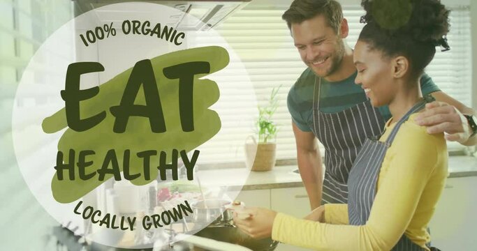 Animation of eat healthy text over diverse couple preparing healthy meal in kitchen