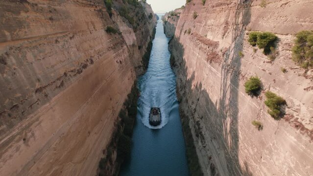 Drone tracking along the corinth canal in Greece, with a ship cruising towards the camera
