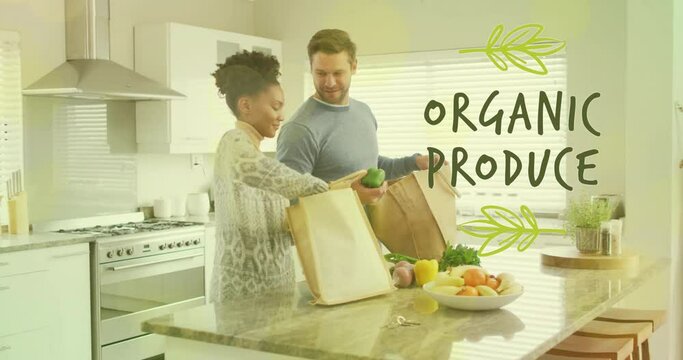 Animation of organic produce text over diverse couple preparing healthy meal in kitchen