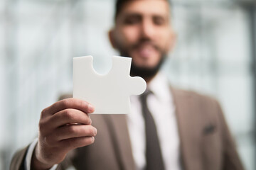 happy businessman holding a puzzle in his hands. Business decisions, success and strategy.