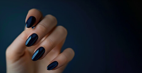 A woman's hand with a beautiful dark blue anecure. Advertising for manicure. - obrazy, fototapety, plakaty