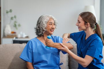 Obraz premium A young Caucasian physical therapist and an elderly Asian woman in her 60s attended a physical therapy course regarding muscle pain and muscle weakness. and heel pain with elastic bands