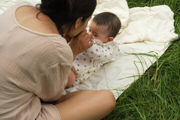 Coziness and care define this scene, a mother and child in a quiet cuddle, surrounded by soft...