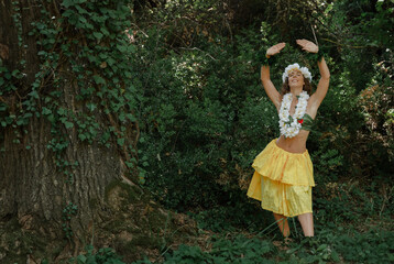 Young dancer performing Tahitian dance in the natural habitat of the jungle. Concept of Polynesian cultural richness. Sensation of tradition and cultural heritage.