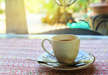 Cup of coffee on the table in coffee shop - obrazy, fototapety, plakaty