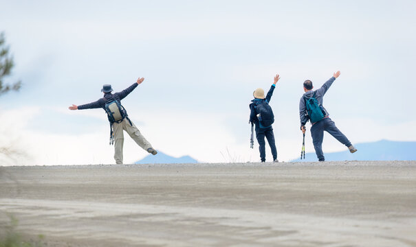 Three hikers posing for fun photos at Denali National Park and Preserve. Alaska. USA.