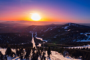 Aerial top view Sheregesh ski lift resort in winter, landscape on mountain with sunset light,...