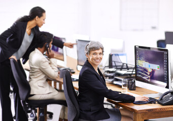 Business woman, portrait and coworking in an office with computer, employees and internet at company. Desktop, professional and female person with technology of website manager at a desk with worker