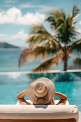 Fototapeta na wymiar Back view of young woman in straw hat relaxing in swimming pool on summer vacation