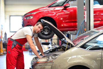car mechanic in a workshop repairing a vehicle