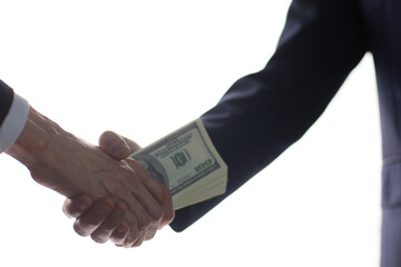 man's handshake and the transfer of money
