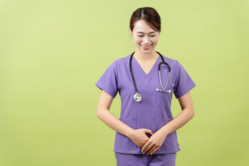 Photo of young Asian femle doctor on green background