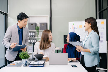 Multiracial group of young creative people in smart casual wear discussing business brainstorming meeting ideas design project.