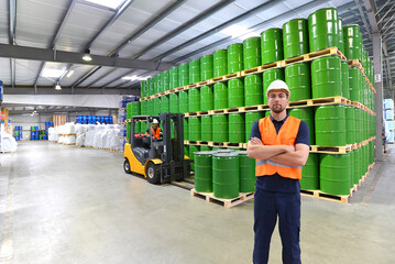 group of workers in the logistics industry work in a warehouse with chemicals