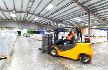 forklift driver in a logistics hall of a chemical warehouse