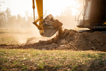 Backhoe working by digging soil at construction site. Bucket teeth of backhoe digging soil. Crawler...