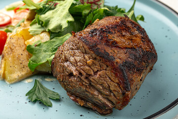 Portion of grilled beef mignon steak with vegetables