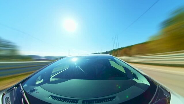 Day Time Lapse Shot of Male Adult Driving His Car on Urban Road. Camera is Placed Outside Vehicle. Speedy Driving On a Road Hyperlapse. Road Trip Travel Concept. Sort of Dashcam POV.