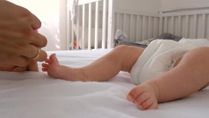 Mom puts on a baby sock. selective focus. child.