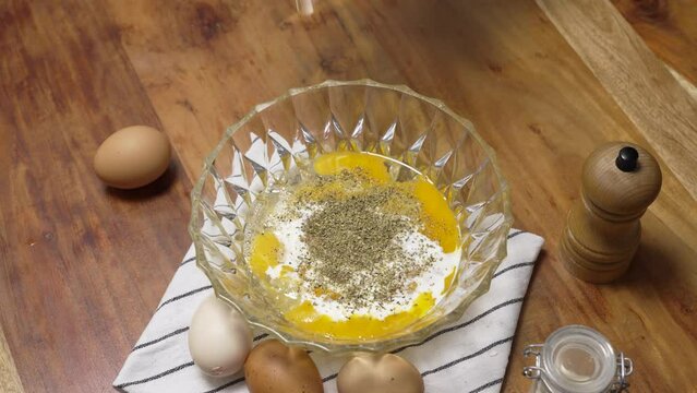 Seasoning mixture of egg salt pepper and milk with herbs