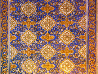 Ornament pattern at the wall of Tilya Kori Madrasa at Registan complex. Gold and blue. Traditional...