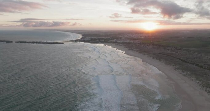 Aerial view of a coastline and waves at sunrise, Peniche, Portugal.