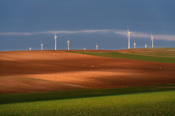 Stunning sunset landscape of Lower Austria adorned with majestic wind turbines. The tranquil beauty...