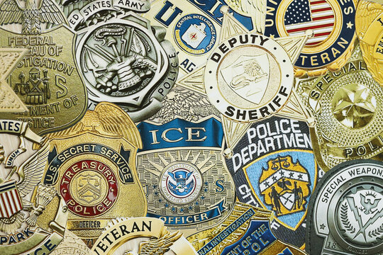 KYIV, UKRAINE - MARCH 9, 2024 Badges of different United States police departments printed on paper close up