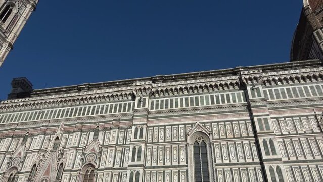 Florence, Italy, seen from below. Details of the cathedral and Giotto's bell tower. View of the Basilica of Santa Maria del Fiore. 4K footage