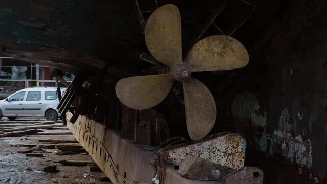 Old propeller on the bottom of the vessel ship. Dry dock. Maintenance and repair