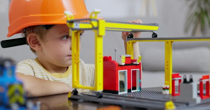 Young Boy Playing Construction Worker with Toys