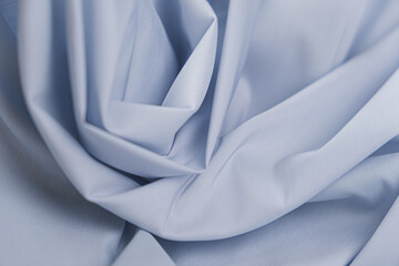 Close-up of texture of cotton fabric in niagara blue color. Background, texture of draped fabric...