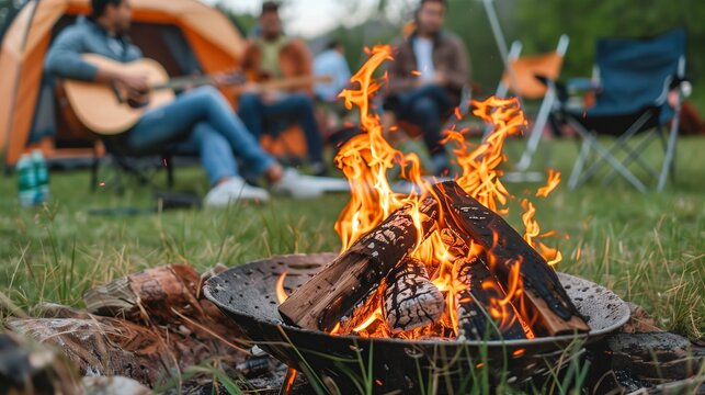 family and friends enjoy a campfire in the forest. Holiday Traveling. Outdoor activity.