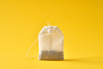 Tea bag on a yellow background.