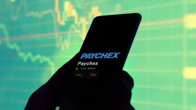 January 15th 2024. The logo of Paychex on the screen of an exchange. Paychex price stocks, $PAYX on a device.