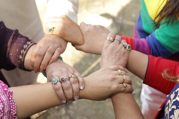 Close up shot of hands. Ladies showing unity. holding each other's hand. diversity, equality. friendship bond. feminine power.