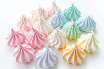 Assorted delicate meringue cookies in various colors, isolated on a white background