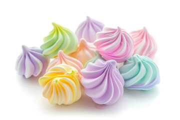Assorted delicate meringue cookies in various colors, isolated on a white background
